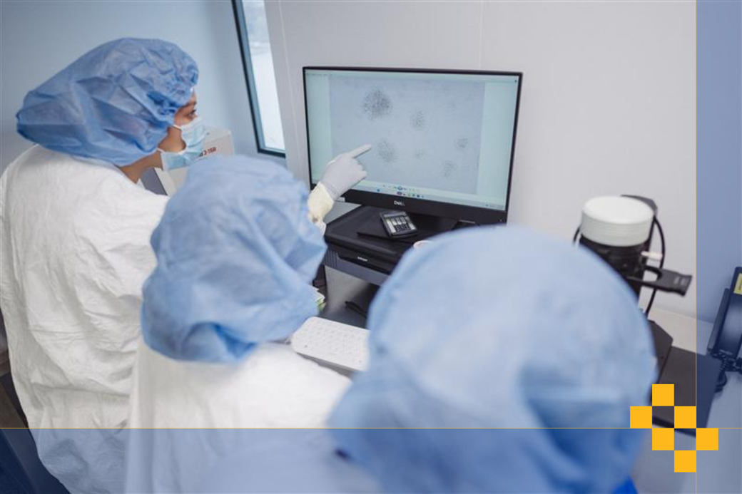 Scientists working at a computer analyzing data in a laboratory.